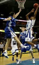 Chris Douglas-Roberts (14) drives to the basket between Middle Tennessee's Kevin Kanaskie (5), Kyle Young (44) and Theryn Hudson (45) in the first half. (AP Photo/Lance Murphey)