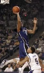 Memphis's Rodney Carney scores two points over Tulsa's Brett McDade (5) during the first half of their college basketball game in Tulsa, Okla., Wednesday, Feb. 1, 2005. (AP Photo/David Crenshaw)
