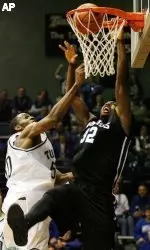 Memphis forward Joe Dorsey, right, dunks the ball in spite of the foul by Tulane center Quincy Davis. (AP Photo/Alex Brandon)
