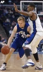 Charles Ramsdell (41) of Tulsa fights his way past Memphis' Shawne Williams, right, during the first half. (AP Photo/Lance Murphey)