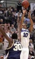 Rodney Carney puts up a three point shot over Oral Roberts forward Caleb Green in the second half.