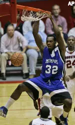 Joey Dorsey - who had 10 rebounds and three blocked shots - hangs on the rim after a dunk in the first half. (AP Photo/David J. Phillip)