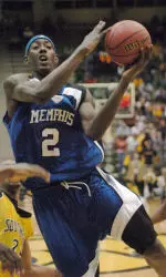Robert Dozier goes between Southern Mississippi guard Jarvis Hill, left, and guard Sai'Quon Stone, right for a lay-up.