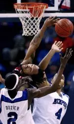 Robert Dozier and Pierre Niles battle Cincinnati's Cedric McGowan for a rebound. (AP photo)