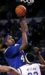 Kareem Cooper shoots over Tulsa's Jamel McLean during the first half.