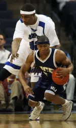 Rice's Lorenzo Williams tries to break loose from Kareem Cooper during the first half.