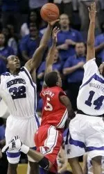 Houston guard Marcus Malone  throws up a shot between Memphis defenders Joey Dorsey and Chris Douglas-Roberts in the first half. (AP)