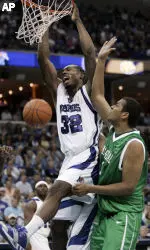 Joey Dorsey dunks the ball in front of Marshall center Robbie Jackson.