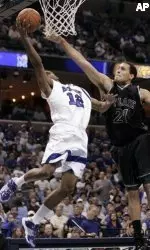 Antonio Anderson goes to the basket as he is defended by Tulane's David Gomez in the first half.