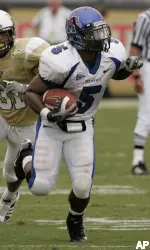 Memphis running back Joseph Doss gains 10 yards as he outruns UCF defender Johnell Neal during the first half. (AP Photo/John Raoux)