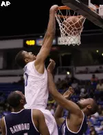 Shawn Taggart dunks over a Xavier player in Memphis' 63-58 loss to the Musketeers.