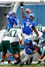 Joel McCleod, top left, and Greg Terrell team up to block a kick in the second quarter of Memphis' 45-6 rout of Tulane.
