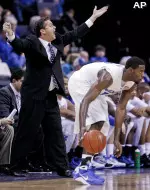Tyreke Evans surveys the floor as Coach Calipari shouts instructions from the sidelines. (AP Photo/Lance Murphey)