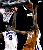 Joey Dorsey and Chris Douglas-Roberts block the shot of Texas guard Justin Mason in the first half. (AP Photo/David J. Phillip)