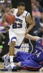 Derrick Rose runs past Kansas' Sasha Kaun during the championship game (AP Photo)