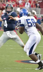 Mississippi quarterback Jevan Sneed (4) attempts a pass in the second quarter as Memphis' Lester Lawson moves in. (AP Photo/Danny Klimetz)