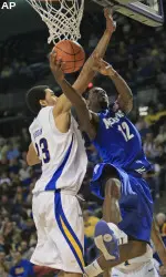 Tyreke Evans goes up for a shot as Tulsa center Jerome Jordan, left, defends during the first half