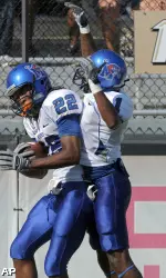Duke Calhoun is congratulated by teammate Cam Baker after scoring on a 61-yard touchdown catch during the first half.