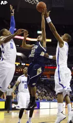 Montana State guard Will Bynum (20) goes to the basket against Memphis defenders Will Coleman (10) and Wesley Witherspoon (11) during the first half of an NCAA college basketball game in Memphis, Tenn., Wednesday, Dec. 9, 2009. (AP Photo/Lance Murphey)