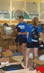 Kailey Kassner and Ellen Roberts sort clothing.