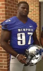 Memphis defensive end Martin Ifedi models one of the Tigers' new uniforms Thursday during the Football by Fuente women's clinic.