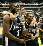Brian Thornton, Will Caudle and Dedrick Finn accept the trophy following XU's 74-55 win.