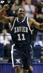 Xavier's B.J. Raymond celebrates as Xavier defeated Brigham Young 79-77 in an NCAA Tournament South Regional first-round basketball game in Lexington, Ky., Thursday, March 15, 2007. (AP Photo/Al Behrman)