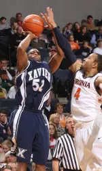 Terry Holloway (52) shoots in front of Virginia guard Calvin Baker