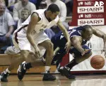 Xavier's B.J. Raymond, right, and Saint Joseph's A.J. Rogers chase after a loose ball during the first half.