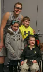 Landyn and his siblings pose with Matt Stainbrook in the media room following Xavier's win against Providence.