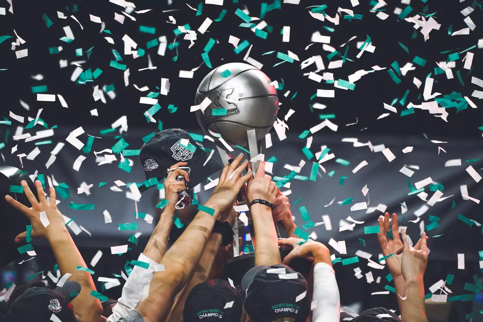 Mar 9, 2021; Las Vegas, NV, USA; Confetti falls as Gonzaga Bulldogs players hoist the trophy after the West Coast Conference Tournament championship against the BYU Cougars at Orleans Arena. Gonzaga defeated BYU 43-42. Mandatory Credit: Kirby Lee-USA TODAY Sports