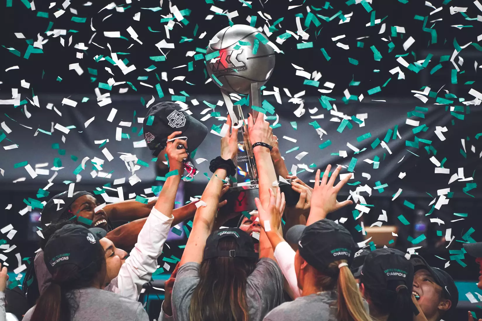 Mar 9, 2021; Las Vegas, NV, USA; Confetti falls as Gonzaga Bulldogs players hoist the trophy after the West Coast Conference Tournament championship against the BYU Cougars at Orleans Arena. Gonzaga defeated BYU 43-42. Mandatory Credit: Kirby Lee-USA TODAY Sports