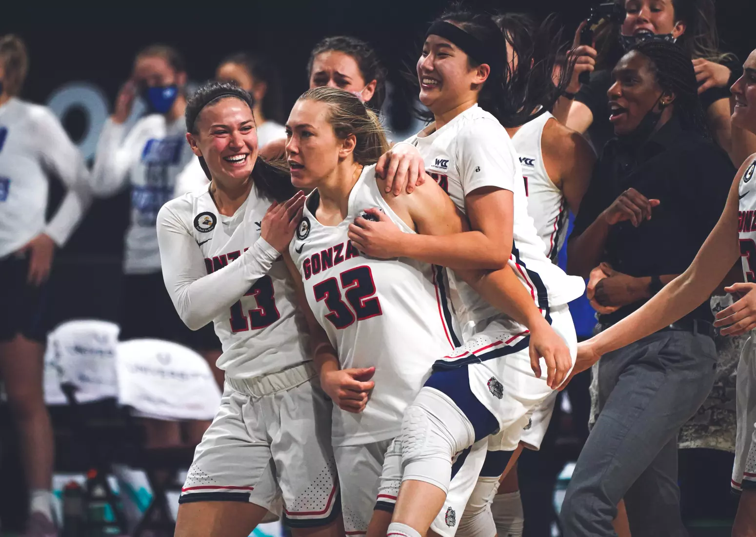 Mar 9, 2021; Las Vegas, NV, USA; Gonzaga Bulldogs guard Jill Townsend (32) celebrates with guards Cierra Walker (13) and Kaylynne Truong (14) after scoring the game-winning basket as time expired in the West Coast Conference Tournament championship against the BYU Cougars at Orleans Arena. Mandatory Credit: Kirby Lee-USA TODAY Sports