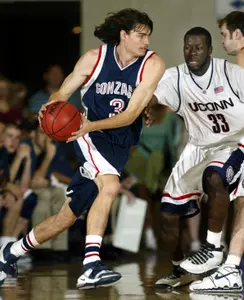 Gonzaga's Adam Morrison, left, drives past Connecticut's Denham Brown in the championship of the Maui Invitational in Lahaina, Hawaii, Wednesday, Nov. 23, 2005. (AP Photo/Michael Conroy