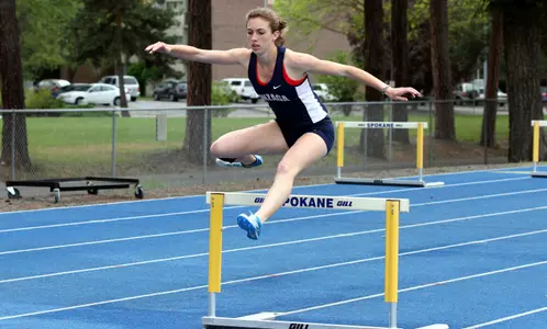 Molly Foster clears a hurdle. (Photo By Torrey Vail