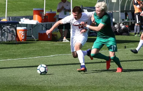 Jake Kempf (14) dribbles the ball away from opponent (Torrey Vail