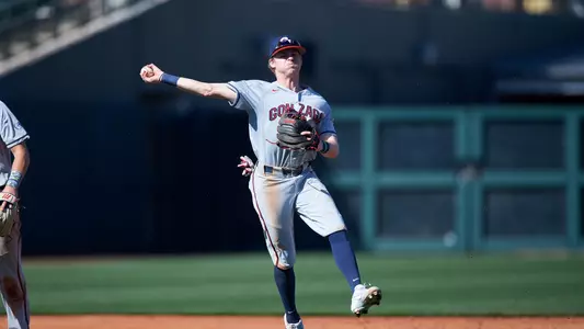 Ernie Yake throws ball to first base