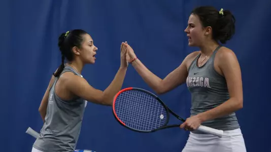 Vlada Medvedcova and Kate Ketels high-five after a point