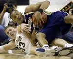 George Washington's Mike Hall, top, and Wake Forest's Vytas Danelius, bottom, wrestle for control of a loose ball.