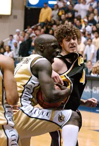 Pops Mensah-Bonsu, left, grabs a pass intended for Towson's Holden Plack in the second half.