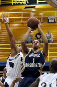 Omar Williams shoots while guarded by Florida International's Junior Matias during the first half Thursday night in Miami.