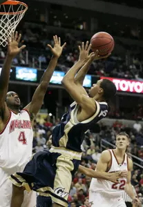 Omar Williams, center, shoots the ball against Maryland's Travis Garrison on Monday night. (AP Photo)