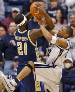 Pops Mensah-Bonsu and Xavier's Dedrick Finn battle for a loose ball during the first half at the Cintas Center Wednesday night, Feb. 23, 2005, in Cincinnati. (AP Photo/The Cincinnati Enquirer, Steven M. Herppich)