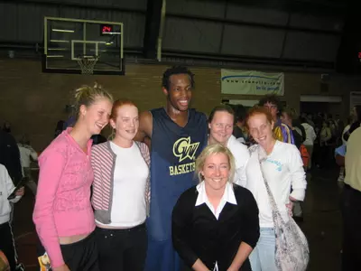 J.R. Pinnock poses with fans after dropping 30 points on the NBL's Sydney Kings Thursday.