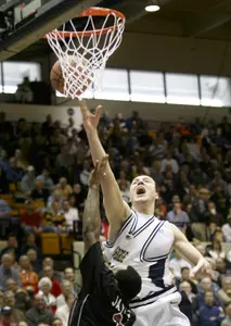 Alex Kireev drives to the basket against Saint Joseph's Abdulai Jalloh during first half action.