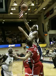 Danilo Pinnock (2) shoots over Stony Brook's Hendrick Feist (5). (AP Photo)