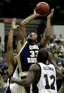 Maureece Rice shoots over Charlotte's Leemire Goldwire in the Colonials' victory. Rice had 21 points off the bench.