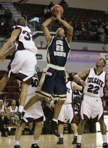Damion Hollis shoots over Colgate's Daniel Waddy, left, in the first half. (AP Photo/Marcio Jose Sanchez)