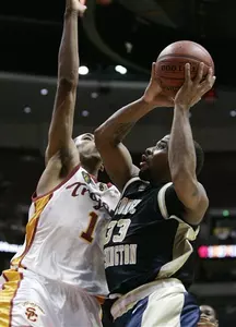 George Washington's Maureece Rice, right, shoots a jump shot against Southern California's Nick Young during the second half.