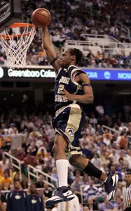 Danilo Pinnock dunks the ball during the second half. (AP Photo/Chuck Burton)